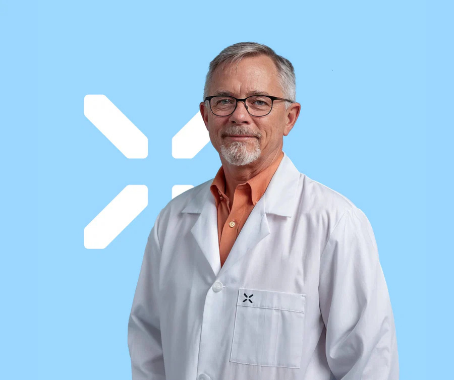 Healthcare provider discussing SHBG genetics and TRT response with a male patient — PlexusDx Precision Peptide Genetic Test
